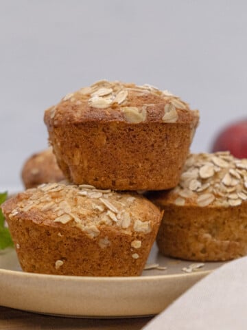 apple oatmeal muffins stacked on plate
