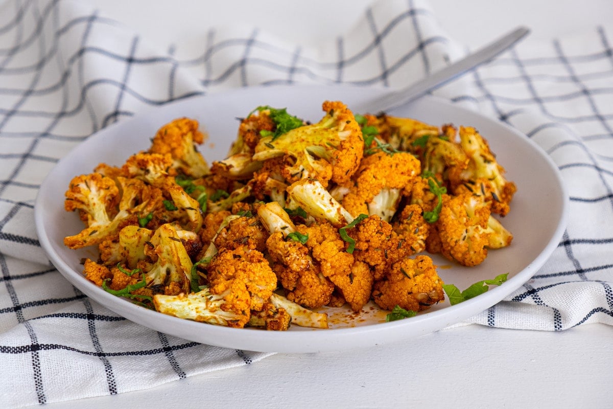 cauliflower on a white plate with parsley