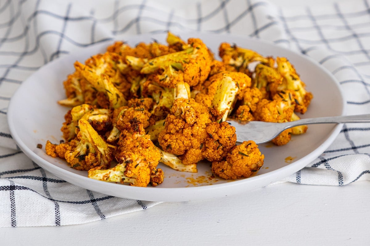 cauliflower with spices on a white plate