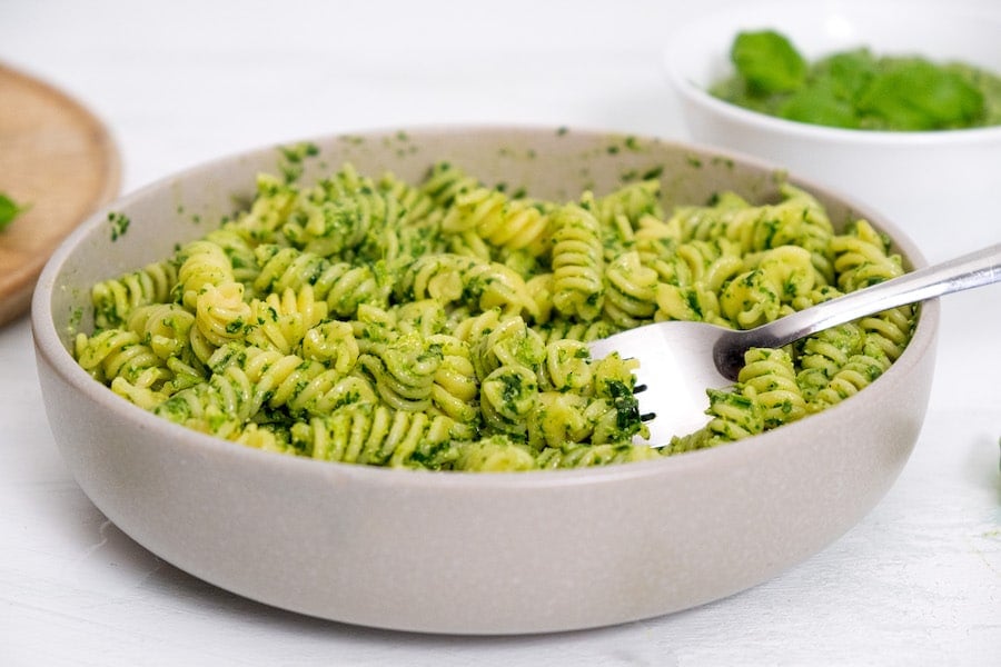 pasta with pesto in bowl with a fork