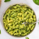 spinach pesto with pasta in white bowl
