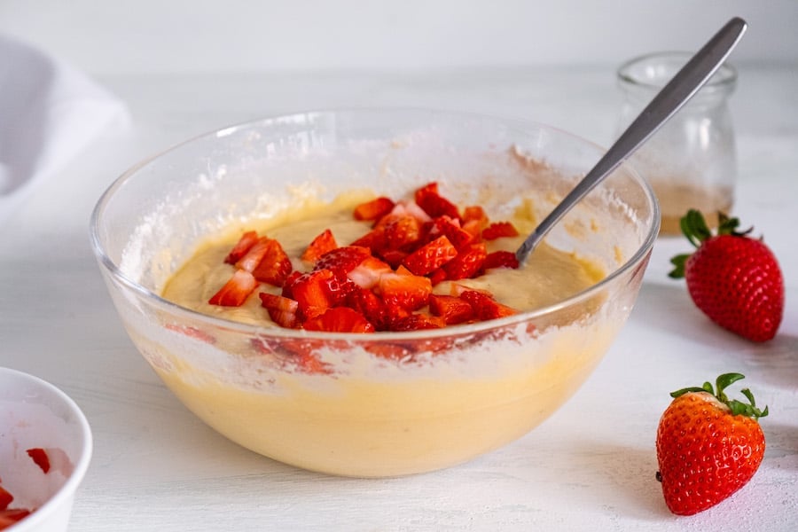 muffin batter with berries on top