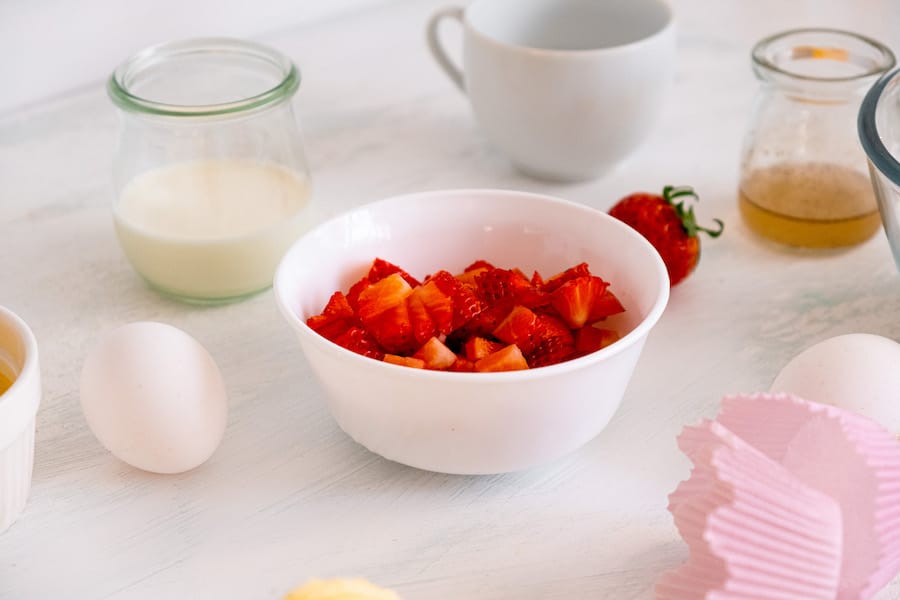 strawberry muffins ingredients on white counter