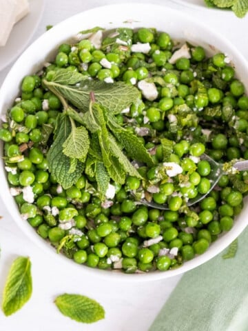 pea salad in a white bowl