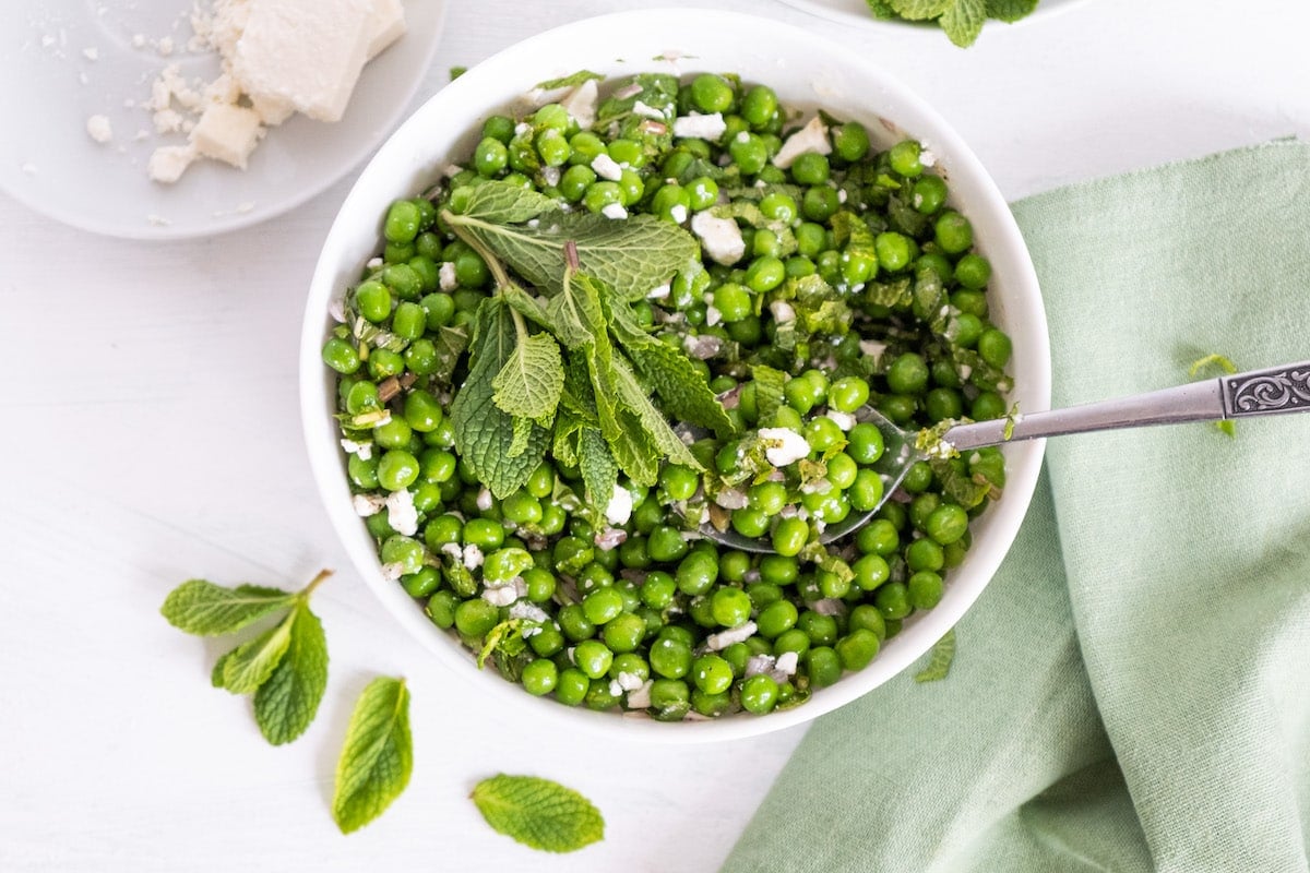 pea salad in a white bowl