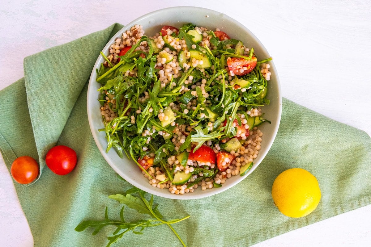 pearl couscous salad in a white bowl