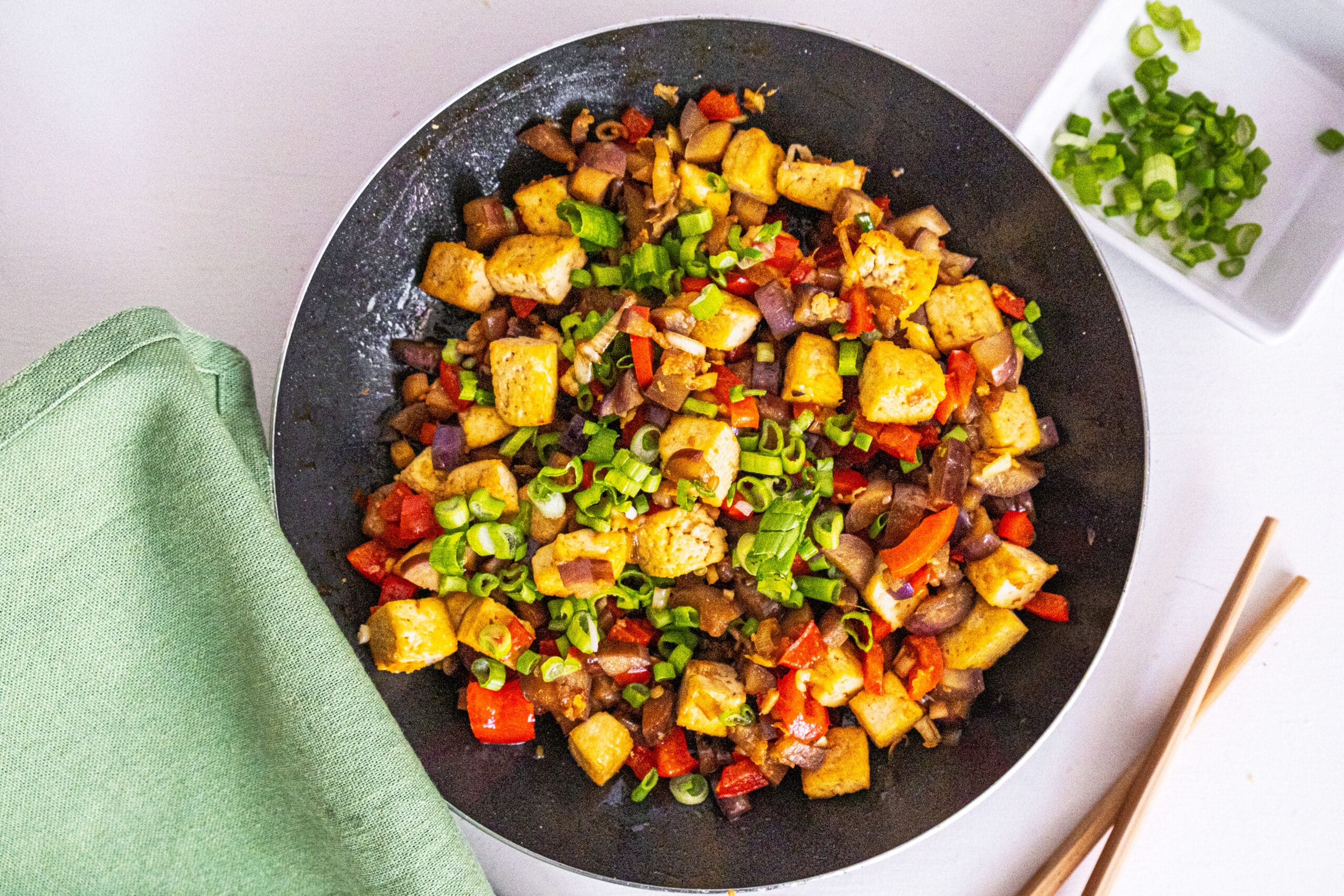 tofu and eggplant on a black plate
