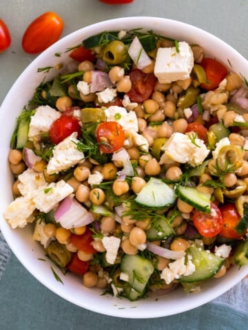 chickpea and cucumber salad in white bowl