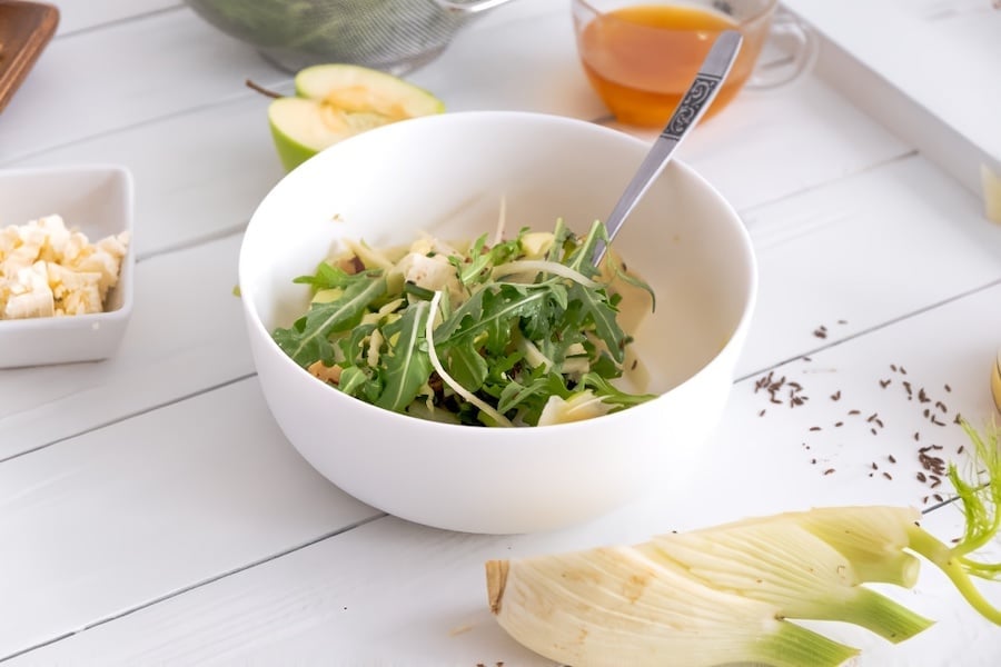 apple and walnut salad in white bowl